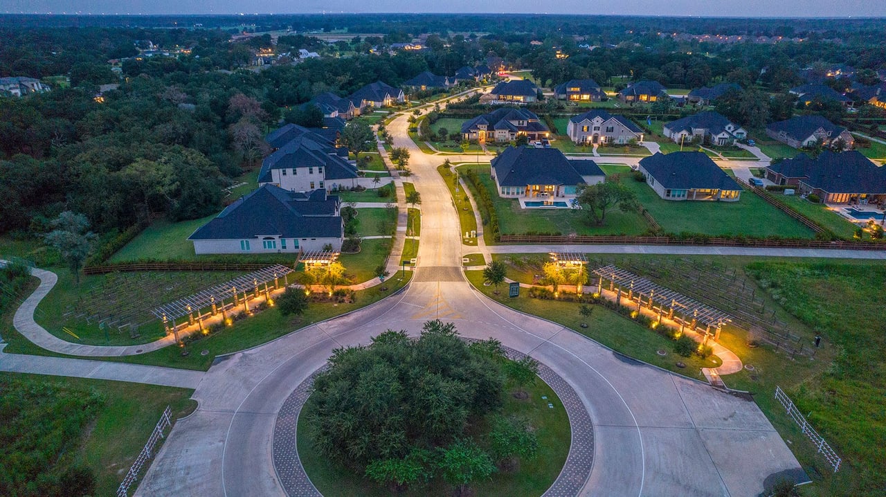 Aerial view of Fulshear Run showcasing scenic tree-lined streets, luxury homes, and green spaces in Fulshear, TX.