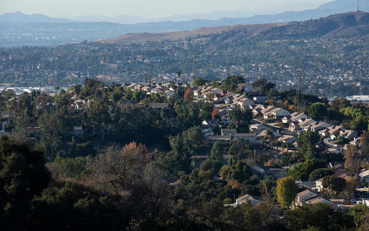 Diamond Bar homes and tree-lined streets spread across rolling hills with hazy mountains in the distance.