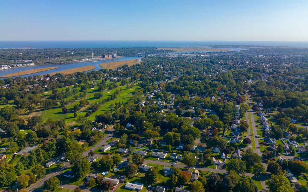 Aerial view of Stratford with a golf course, river, marshland, and Long Island Sound in the distance.
