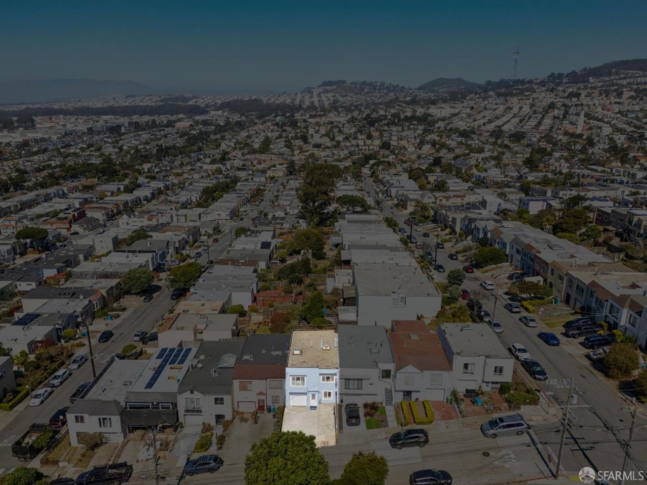 Aerial view of a residential neighborhood, with one house highlighted near the foreground.