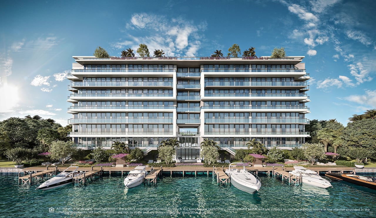 La Baia waterfront condominium with glass balconies, landscaped grounds, and boats docked along the shore.