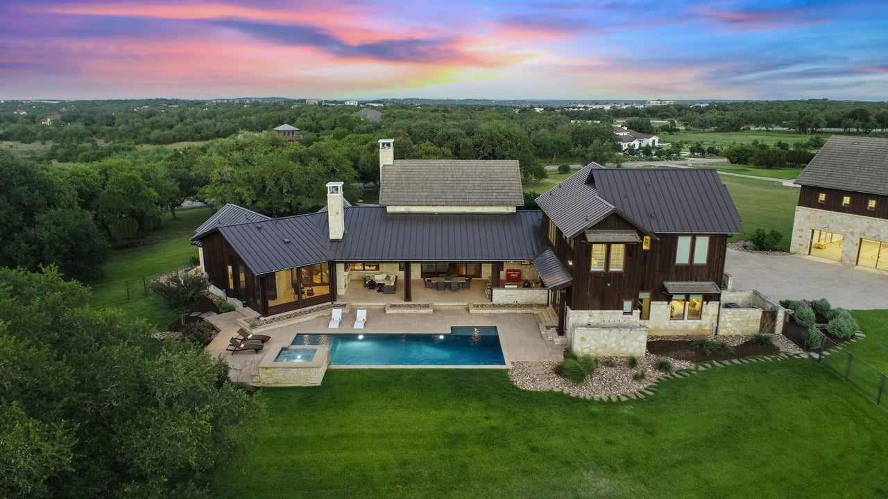 Drone aerial of the hill country estate at 335 Winning Colors, showing the pool and surrounding acreage in Key Ranch at the Polo Club.