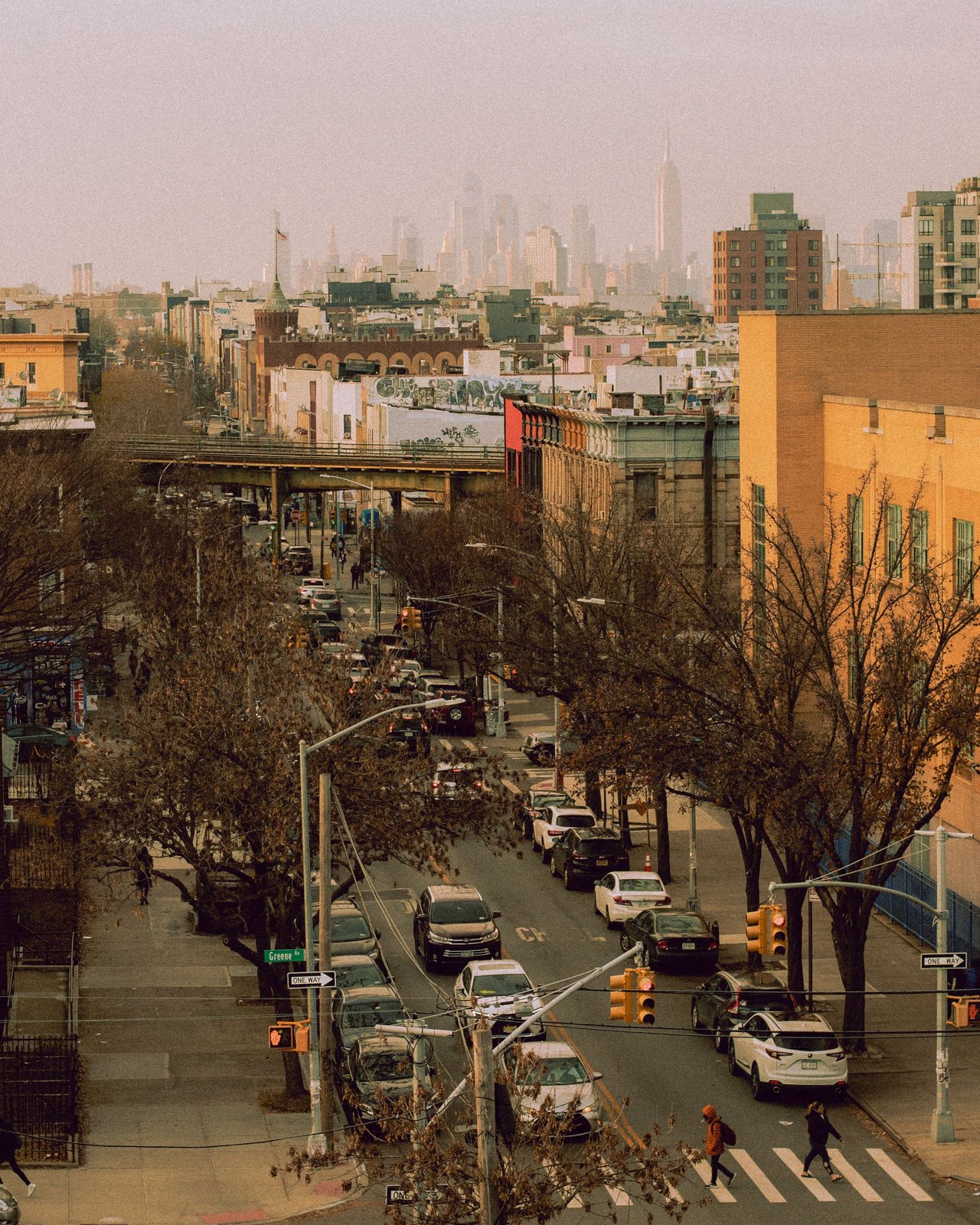 Historic mixed-use buildings, multifamily homes, townhouses, and retail storefronts along Broadway in Bushwick, Brooklyn.
