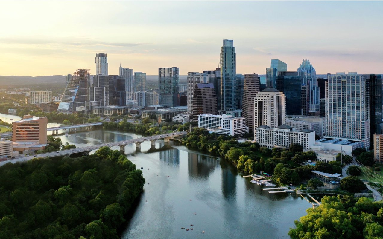 Downtown Austin city skyline with a river in the foreground and a bridge in the background