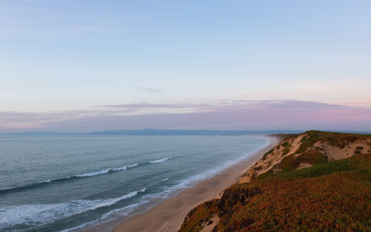 aerial photo of beach and beach shore with purple sunset in Montrey