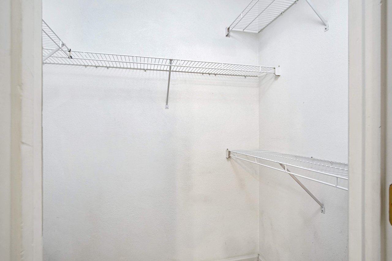 Photo of white walk in closet with four racks for built in shelving and storage  at 2709 Oak Park Court, Tallahassee, Florida 32308