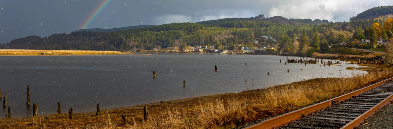 a rainbow with deep grey sky over the homes of Wheeler oregon