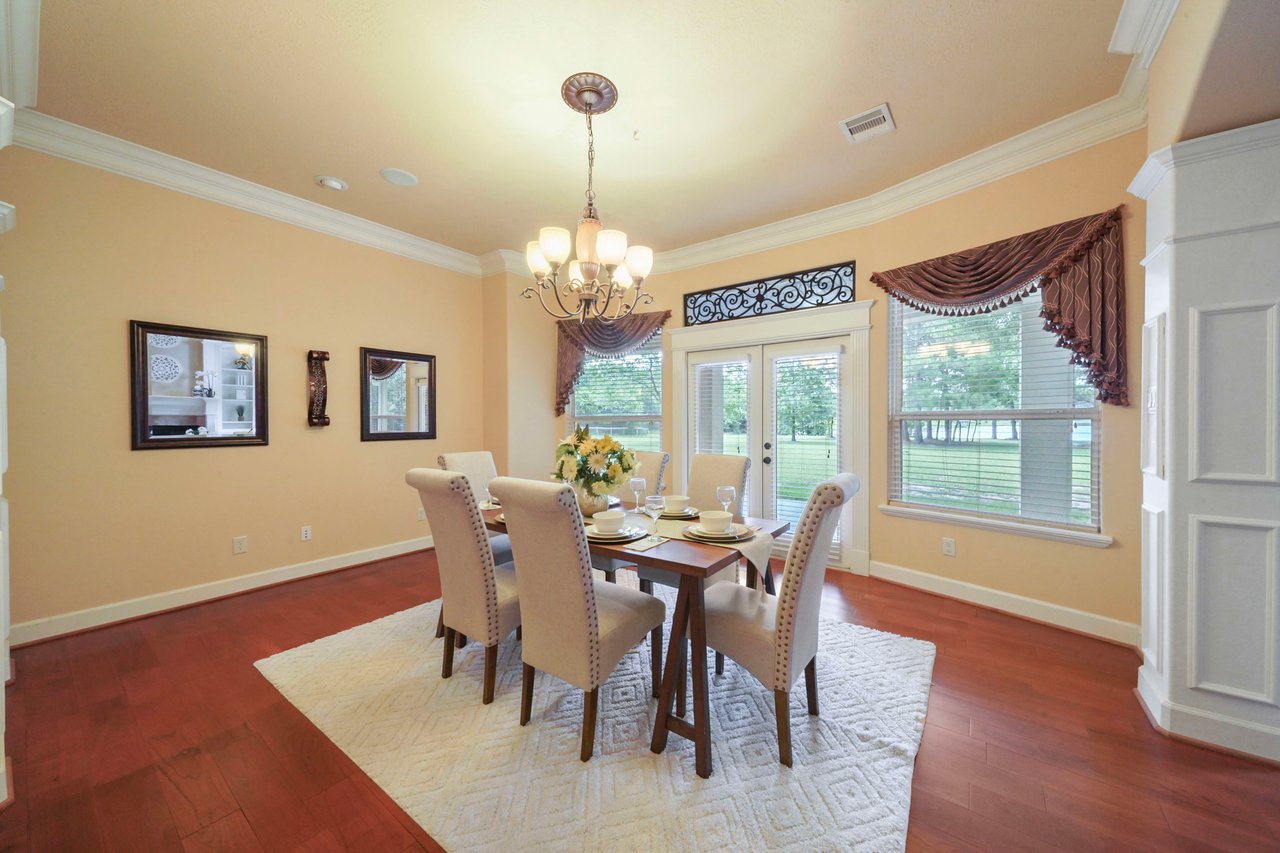 Formal dining room (16'x14') with double doors leading to the expansive back covered patio.