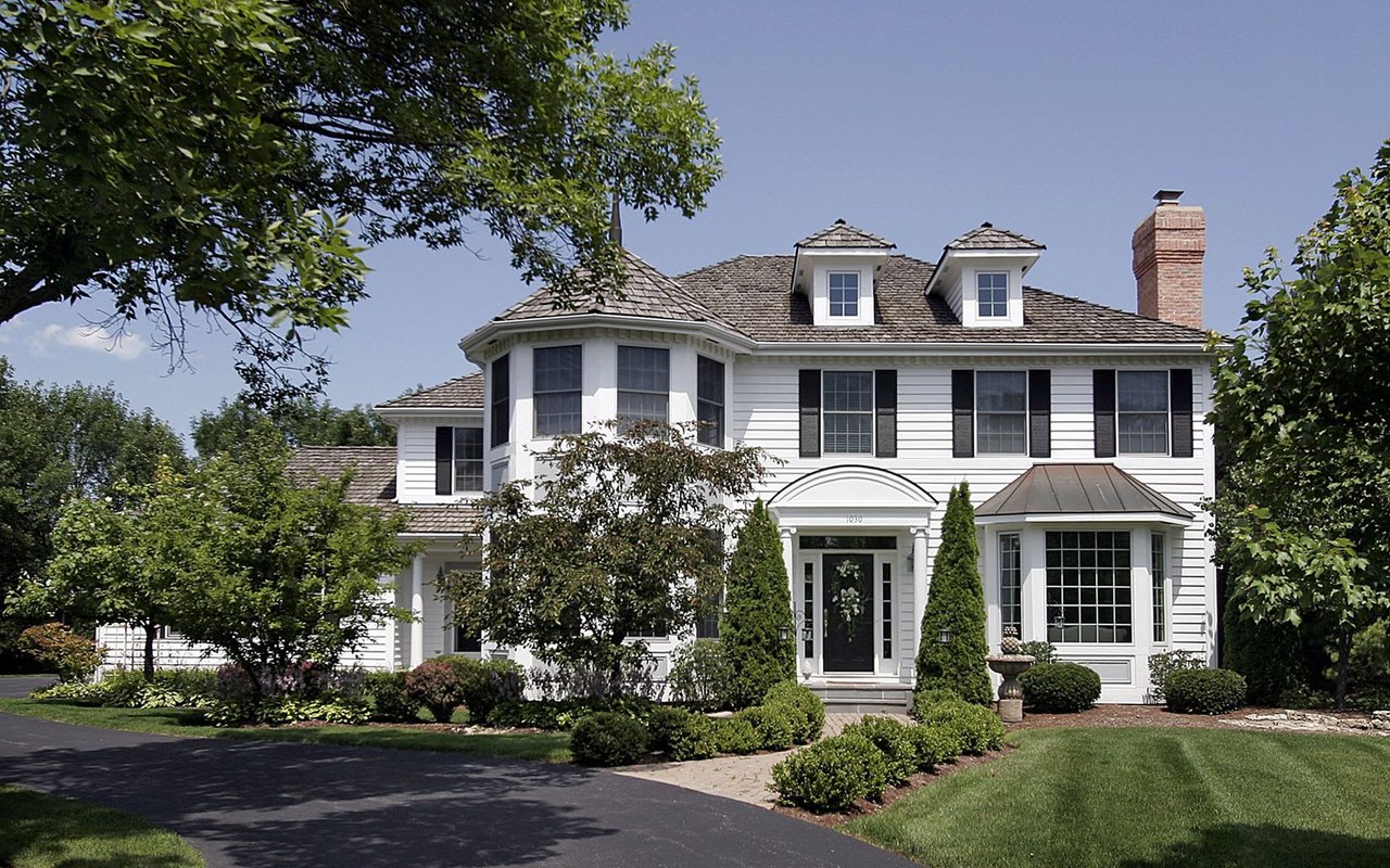 A modern two-story house with a dark gray exterior