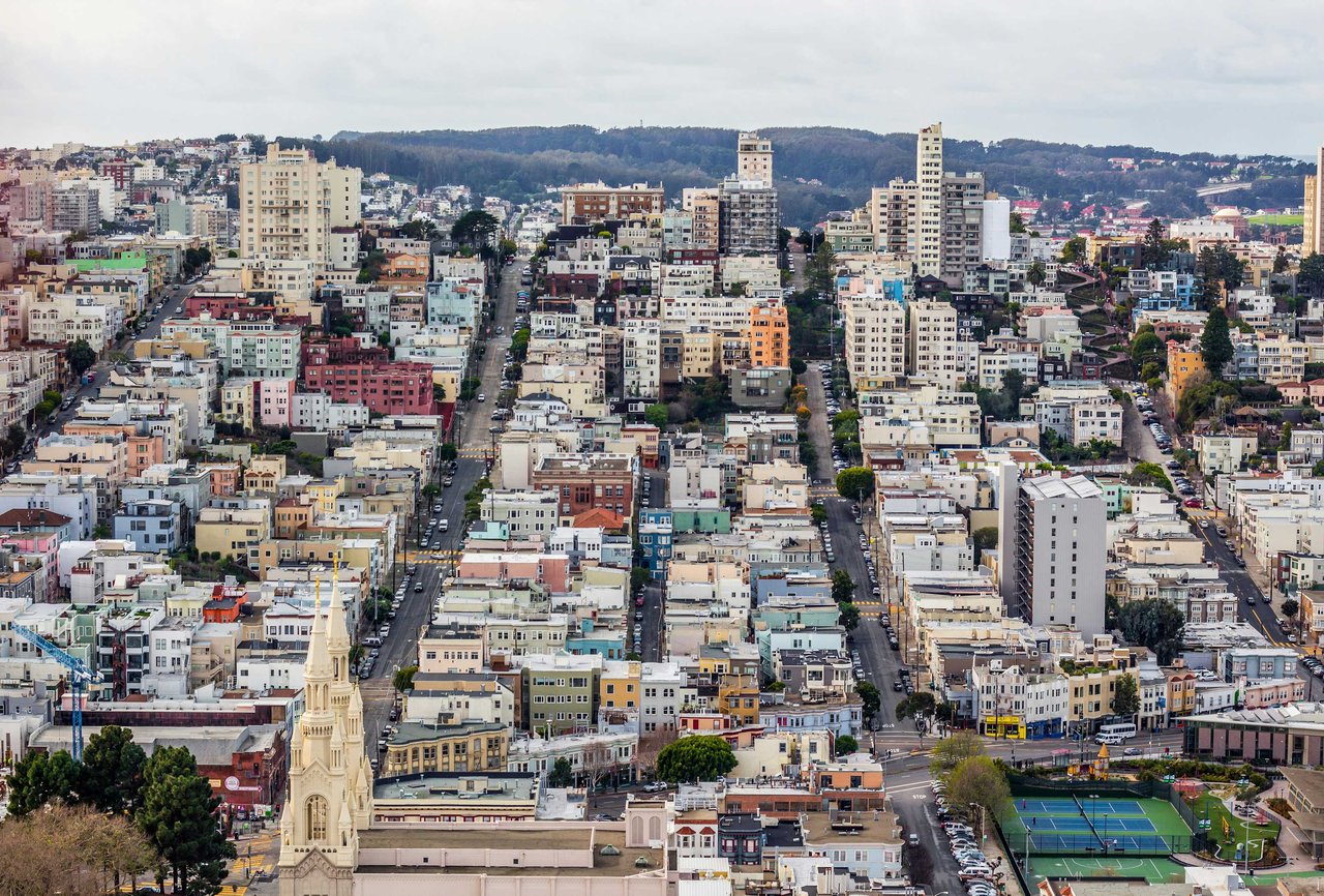 Aerial view of Lombard Street in the Russian Hill neighborhood of San Francisco, California, showcasing residential homes, tree-lined streets, and classic urban architecture.