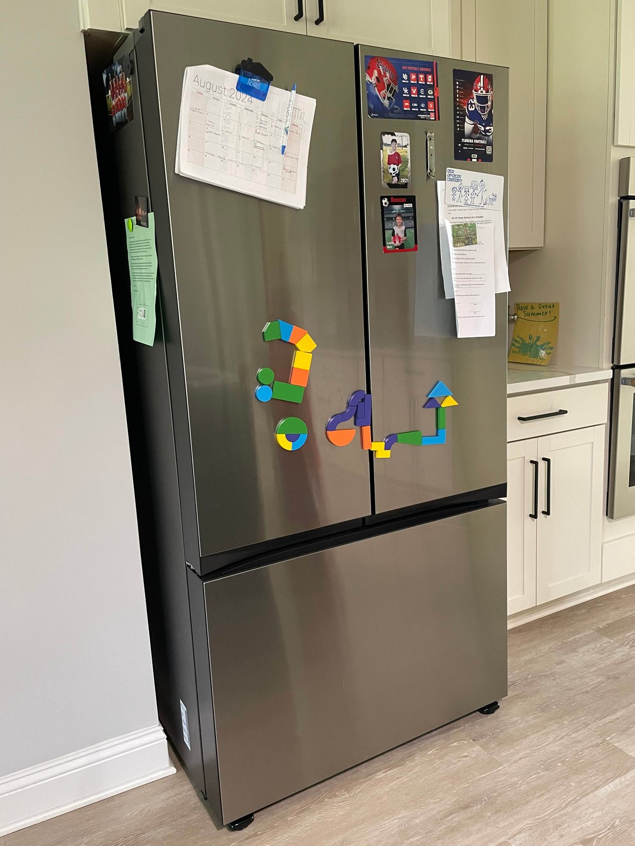 refrigerator with magnets, calendars and lists