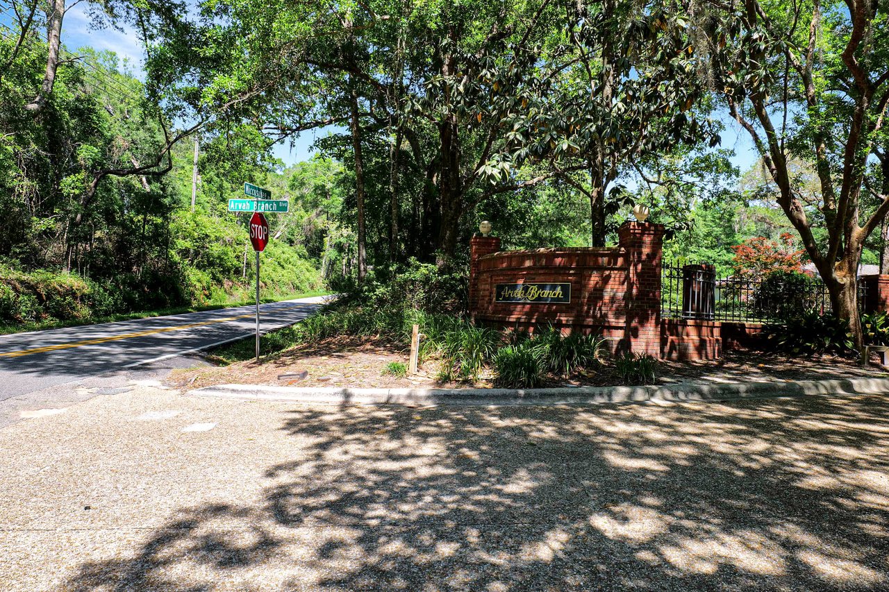 A view of a street in Arvah Branch, showing the entrance area with trees and well-maintained surroundings.