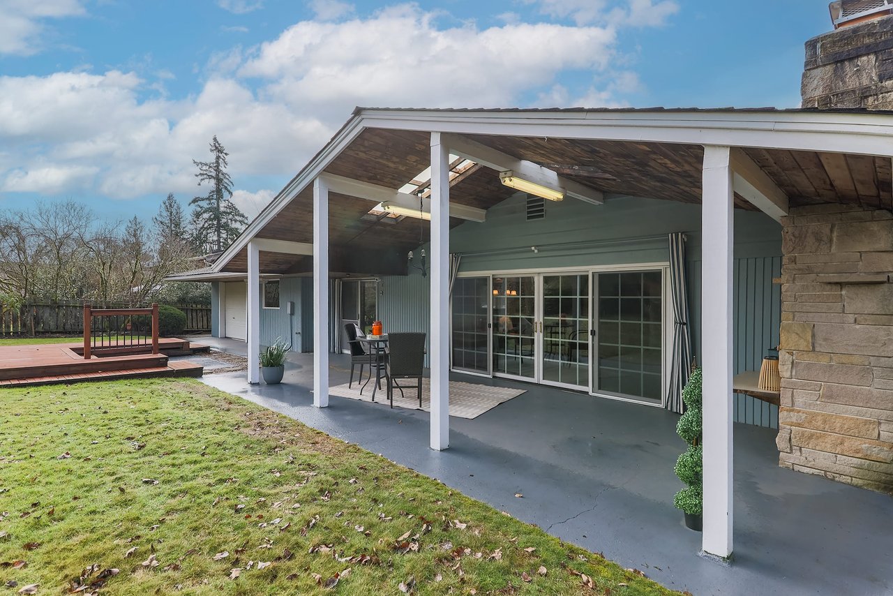 Experience year-round outdoor living with a covered porch, providing a cozy retreat even in the rain, where you can enjoy the beauty of nature in comfort.