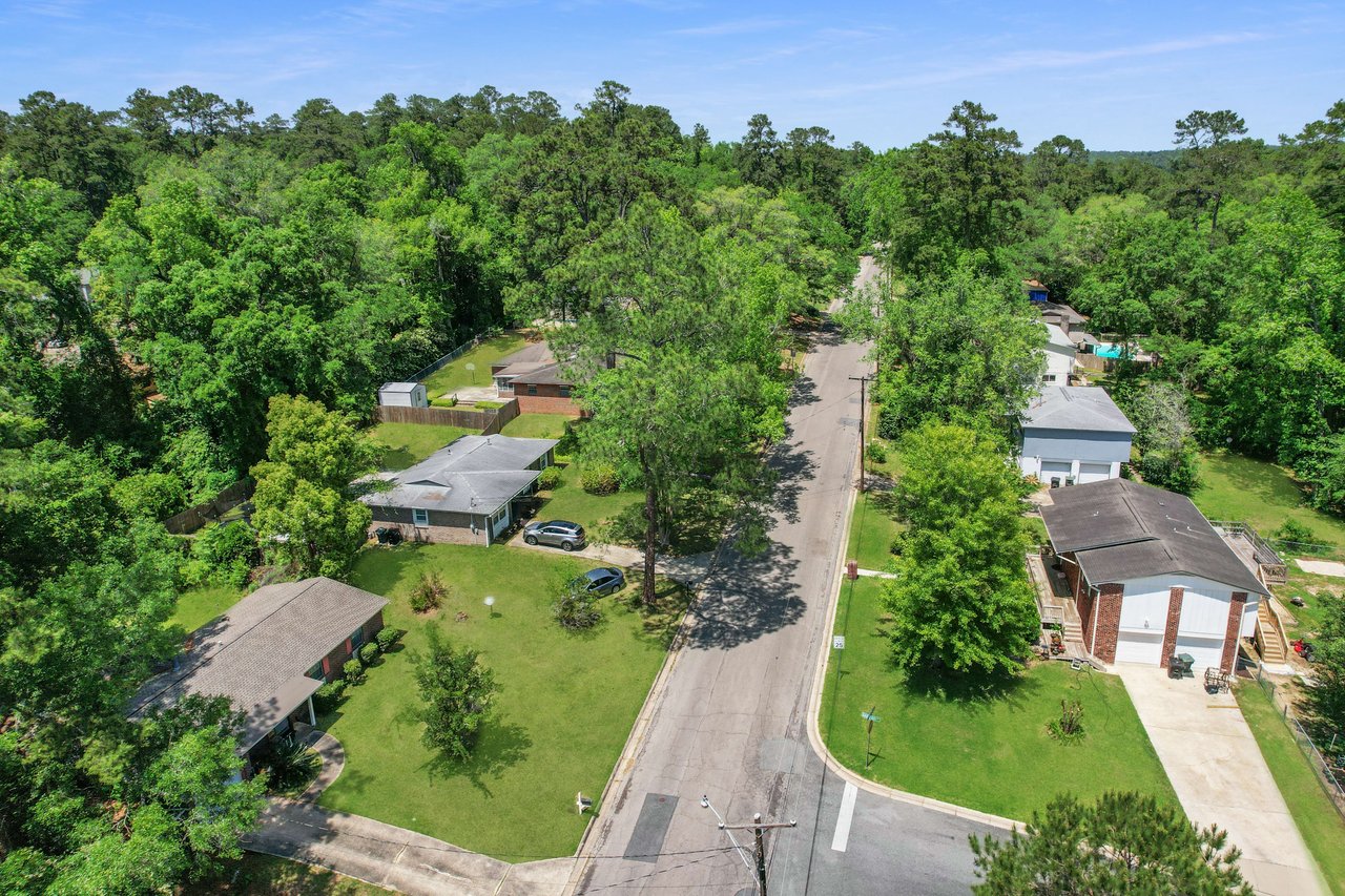 An aerial view of Town and Country, focusing on a section of the community with houses, roads, and nearby commercial areas. The image provides a glimpse of the broader neighborhood.