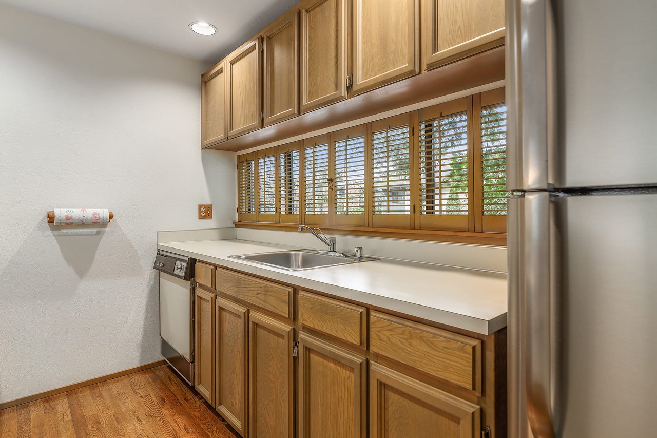 Discover culinary inspiration in the kitchen adorned with ample windows and cabinets, combining natural light with abundant storage for a practical yet delightful cooking experience.