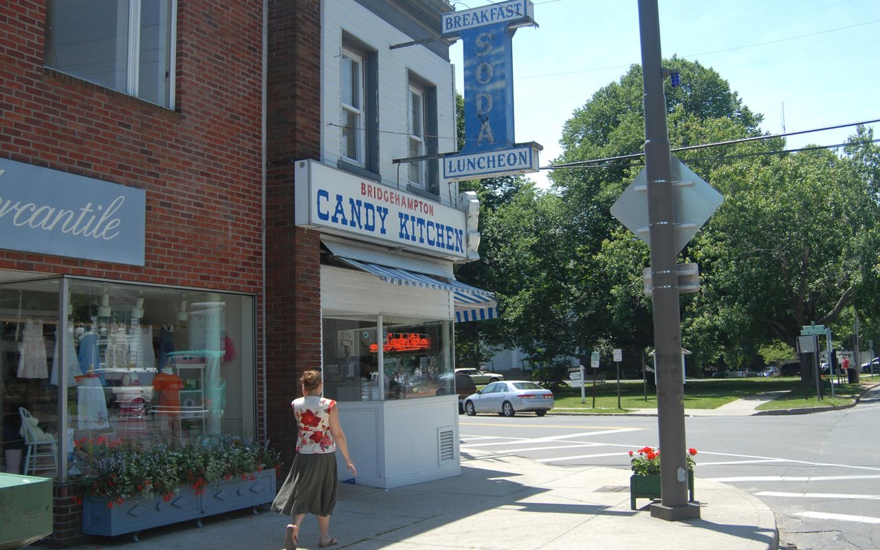 Brick building in the city with intricate details and diverse shops.