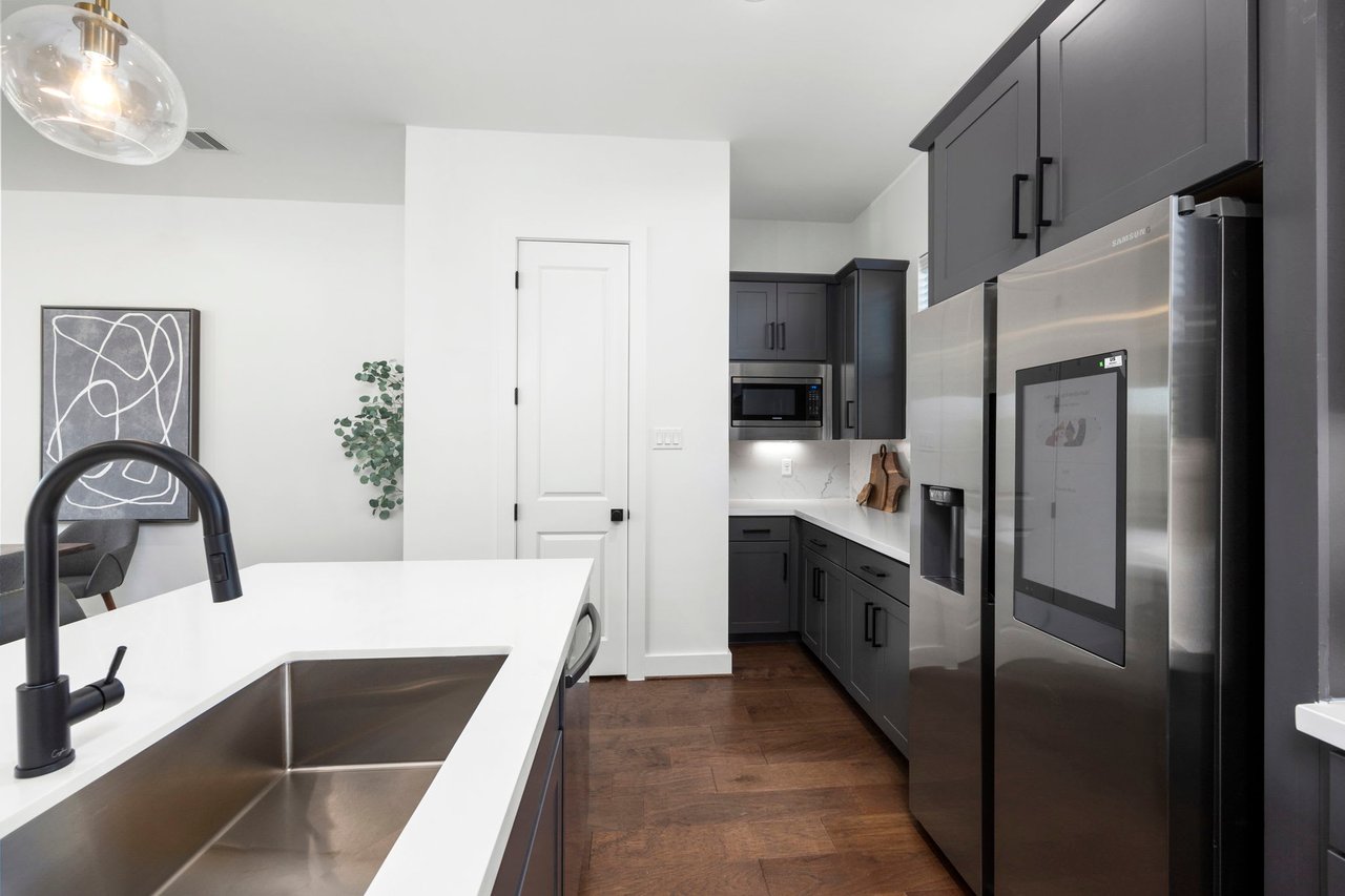 newly built kitchen with silver appliances 