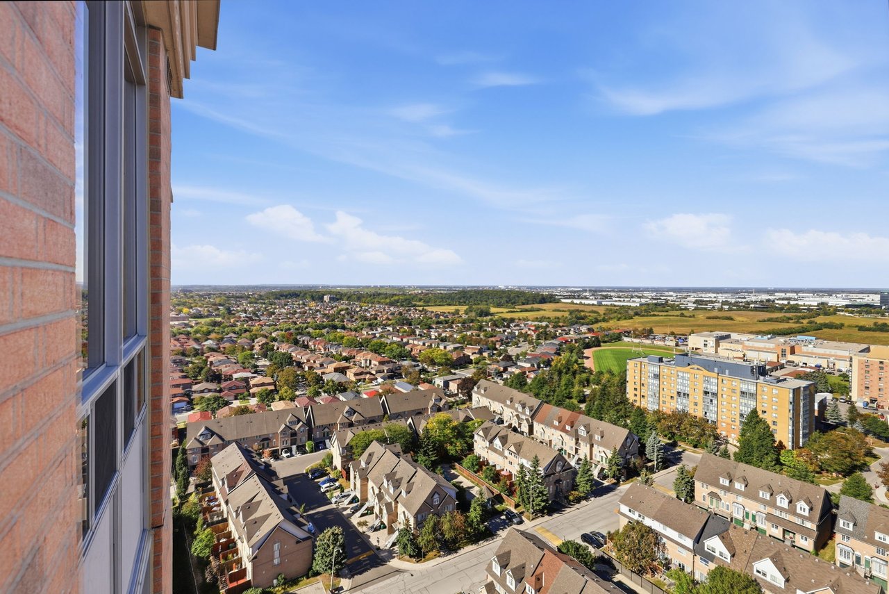 High-rise view over Mississauga’s suburban homes, apartment buildings, and green fields.
