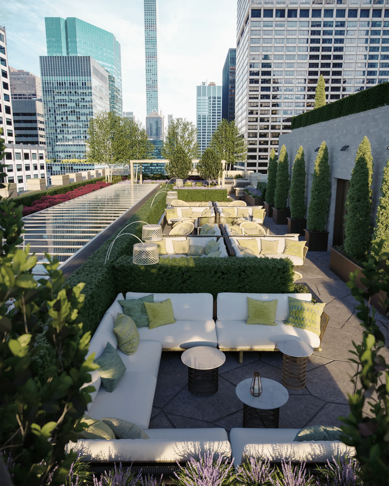 Rooftop terrace with white lounge seating, lush planting, and surrounding Manhattan skyscrapers.