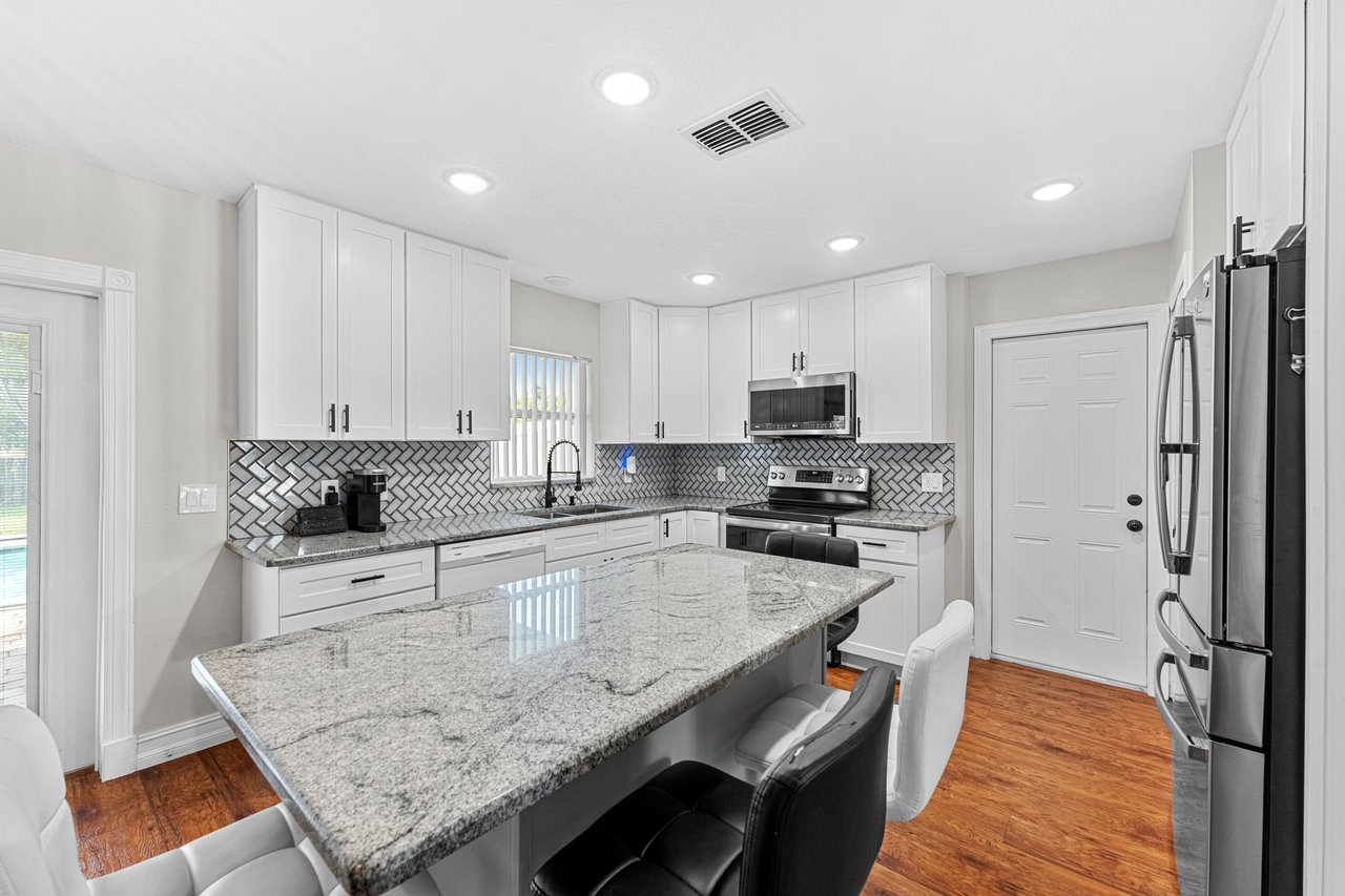 Remodeled 2023 kitchen with breakfast bar and abundant cabinetry