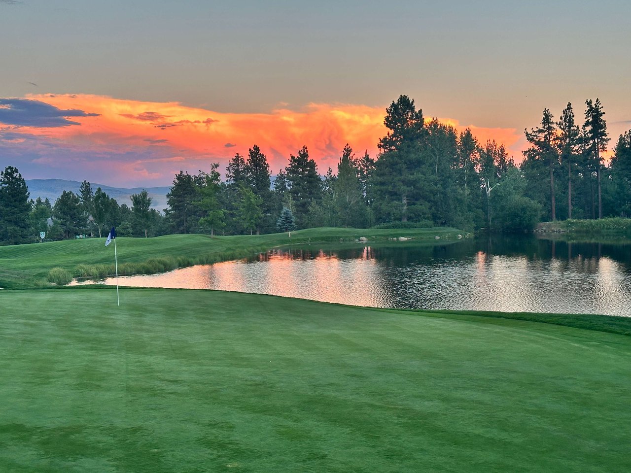 Montreux golf community at sunset with pond and mountain views, a luxury neighborhood near Reno and Lake Tahoe.