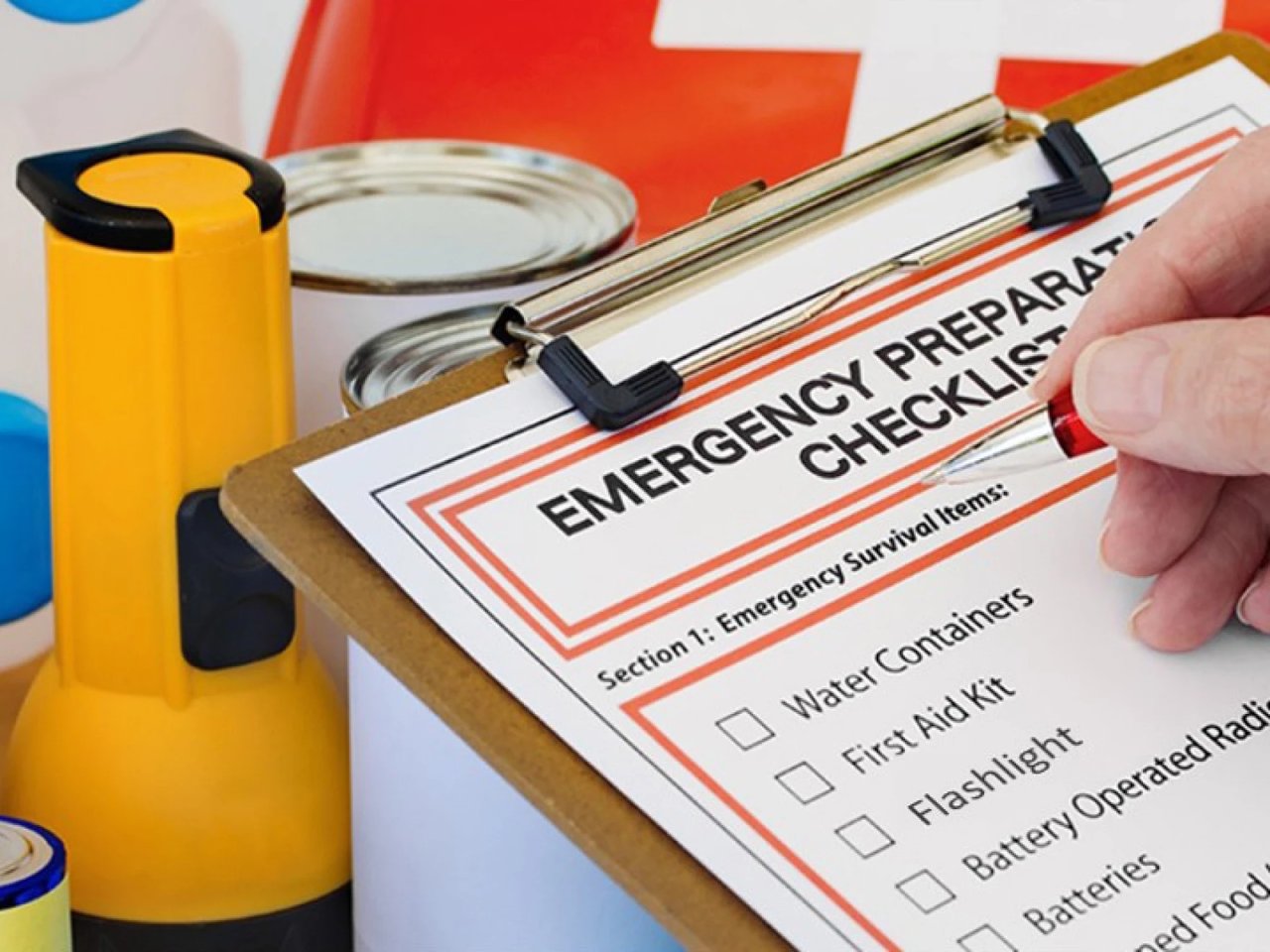 A complete hurricane supply kit including water, batteries, flashlight, canned food, and first aid supplies for Tampa residents.