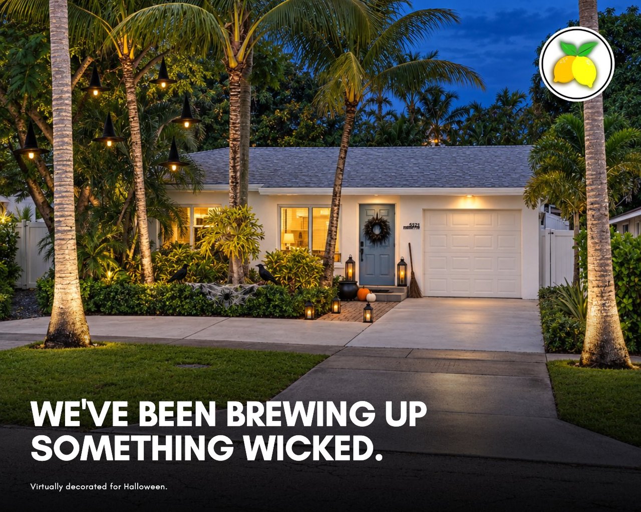 Renovated white single-story home with a blue front door and palm trees at 5521 Parker Avenue in West Palm Beach, Florida, virtually decorated for Halloween at dusk