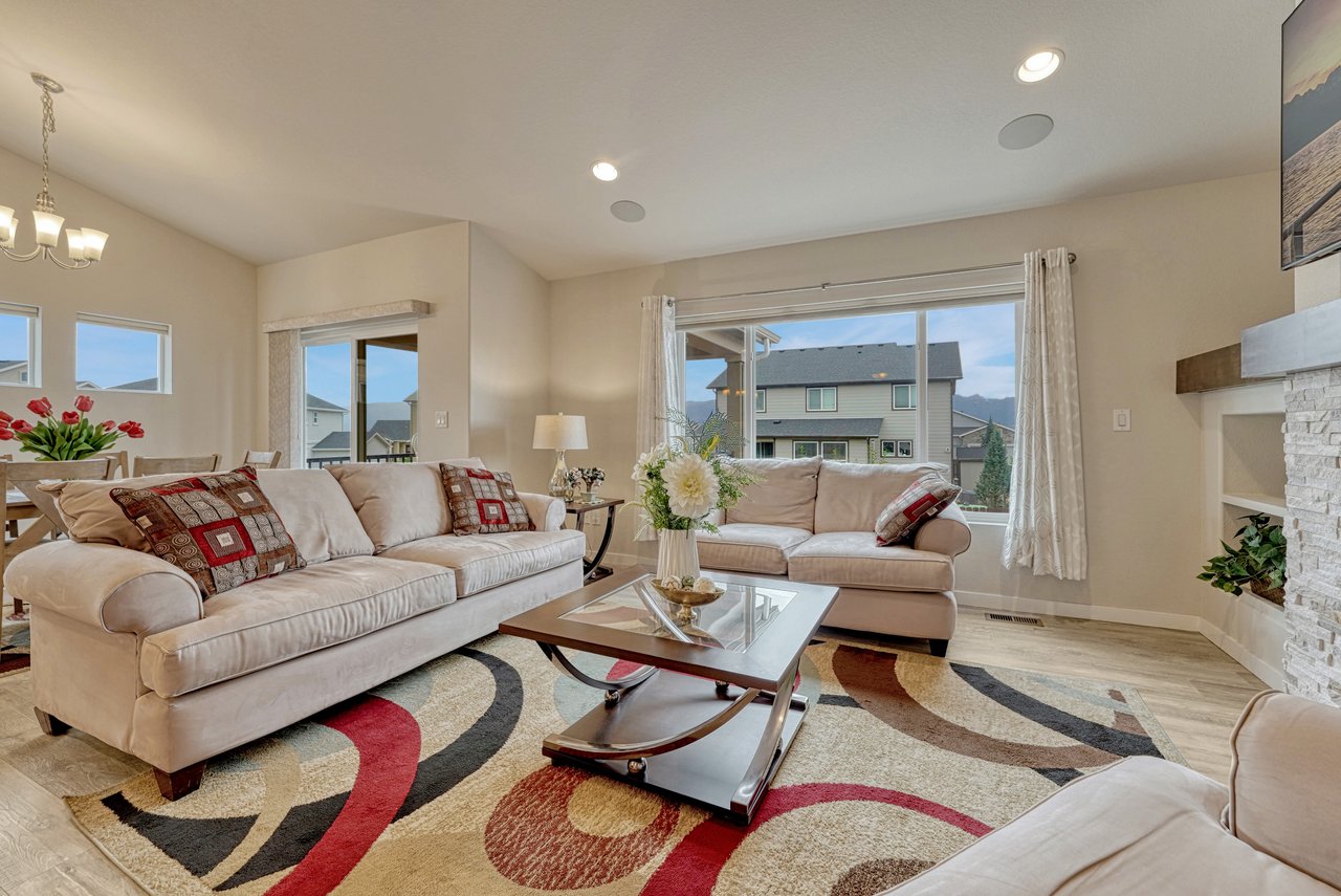 Living room with a large picture window and open view to the dining area