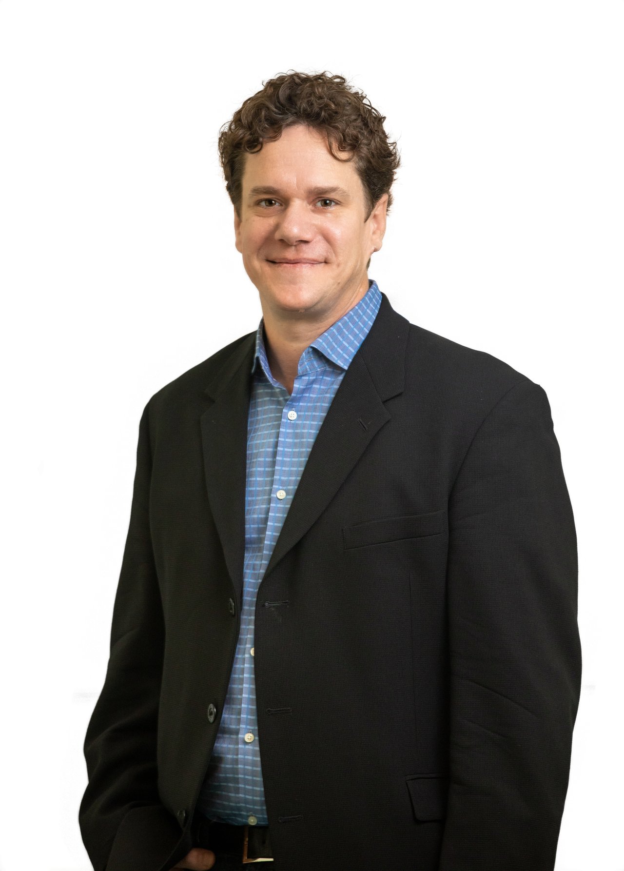Nick Tarantola in a black blazer and blue checked shirt.