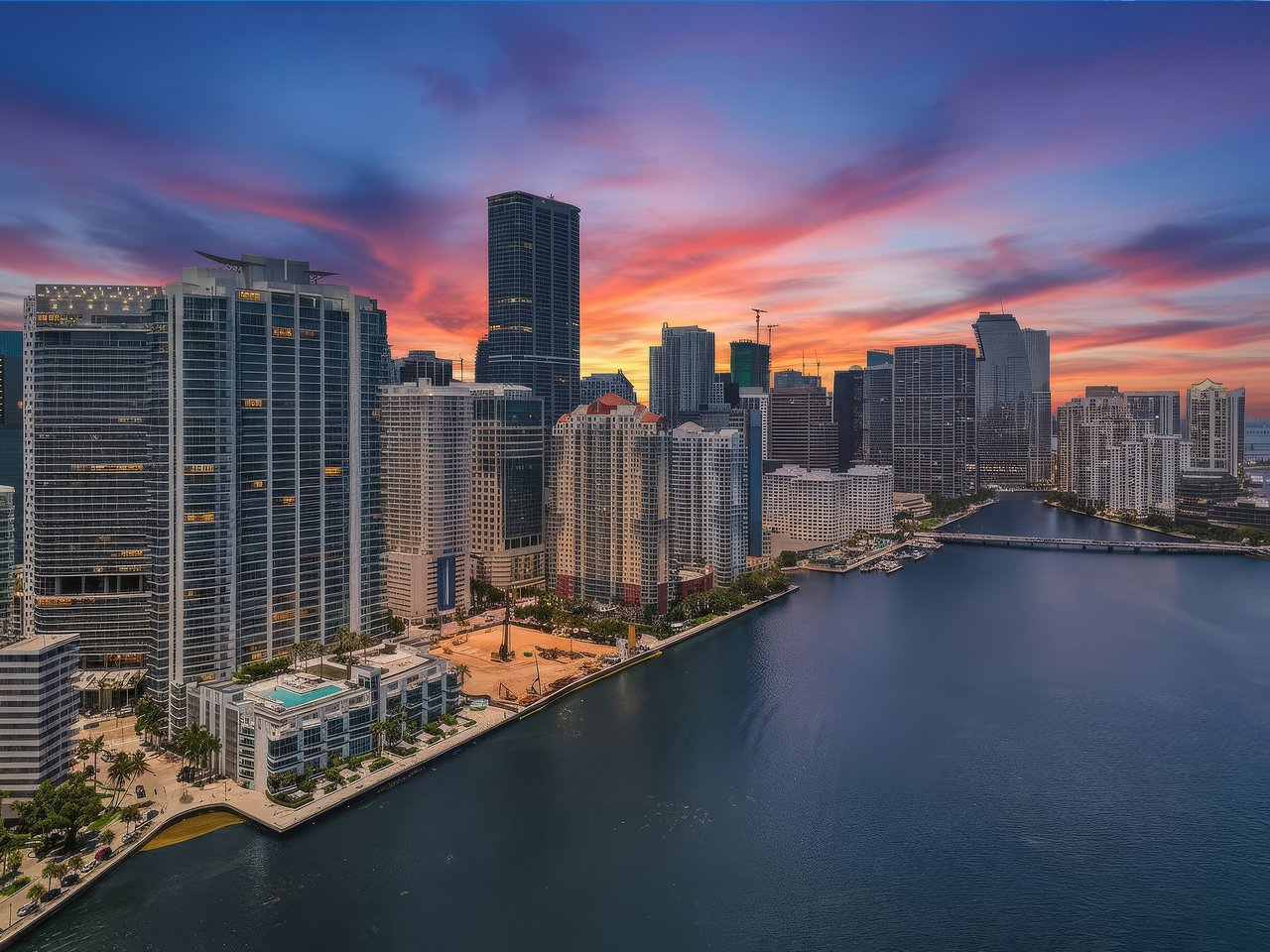 Digitally enhanced twilight aerial view of the Brickell waterfront and Biscayne Bay near Jade Residences in Miami