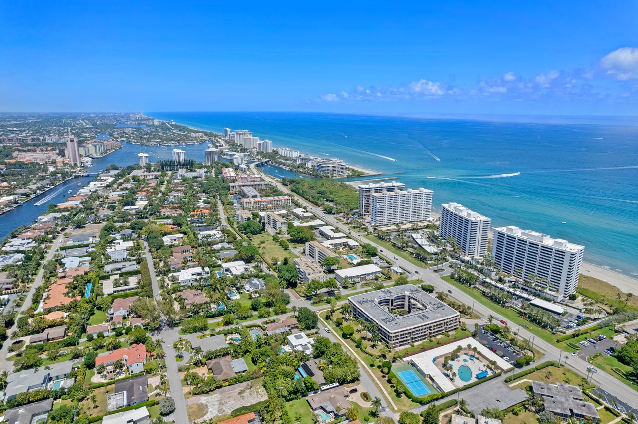 Aerial view of East Boca Raton’s coast, with oceanfront towers, residential streets, and canals.