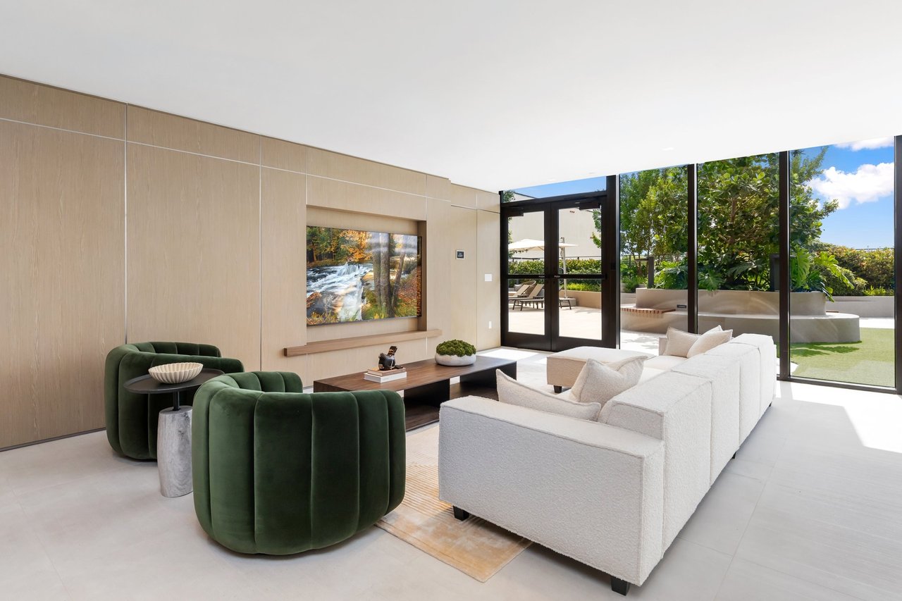 Arbor Coconut Grove social lounge with green armchairs and garden views