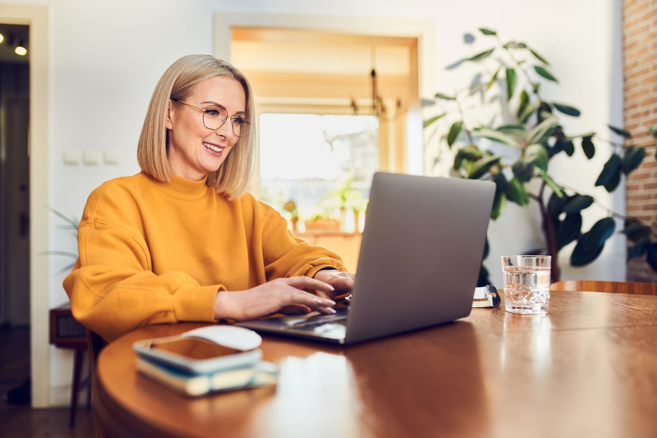 Should I Buy A Home or Sell My home First, Woman at Computer - Graham and Kelly Levine Carlsbad and North County San Diego Real Estate