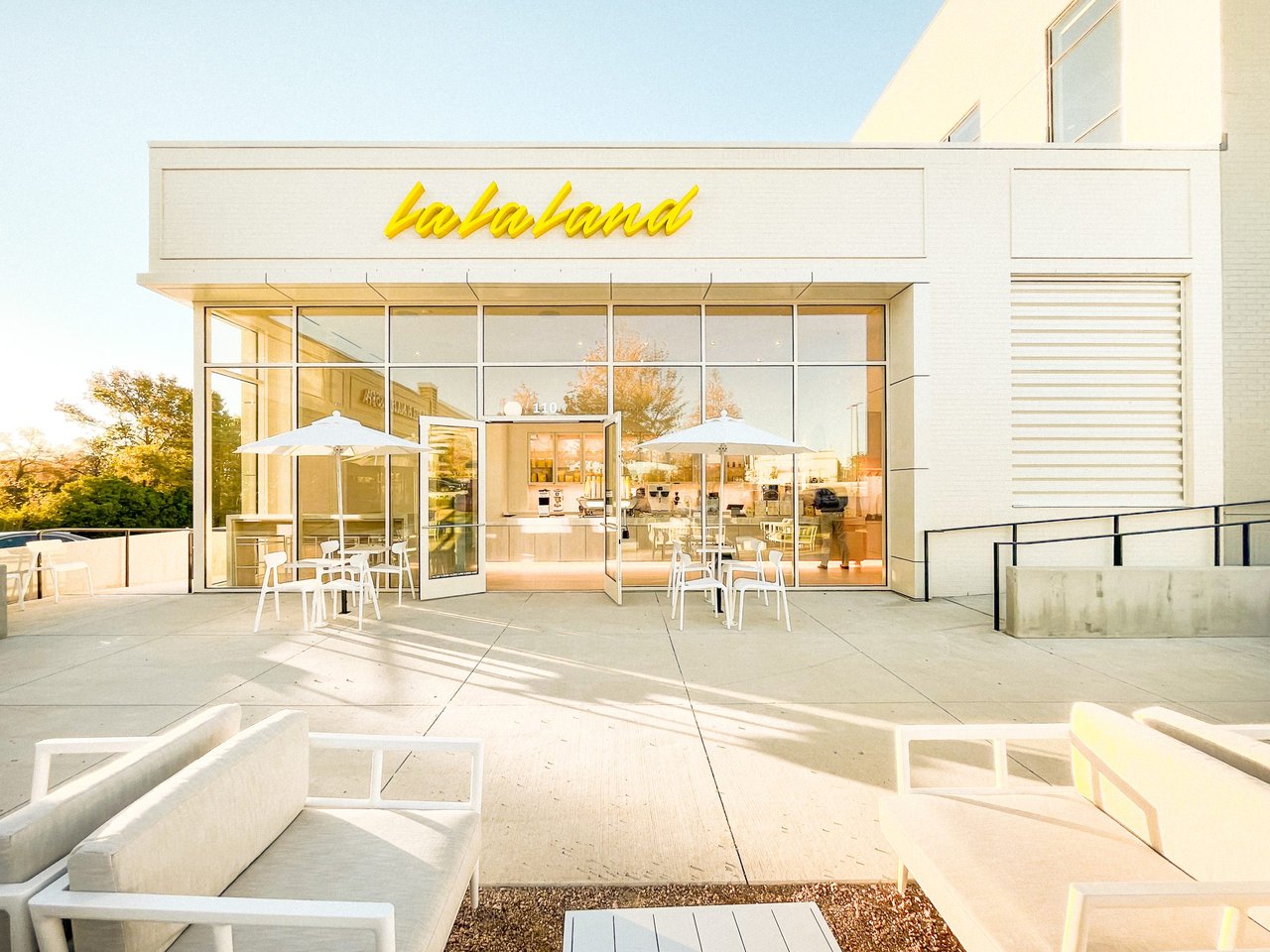 Exterior of a bright, colorful coffee shop on a bustling street in Costa Mesa, California