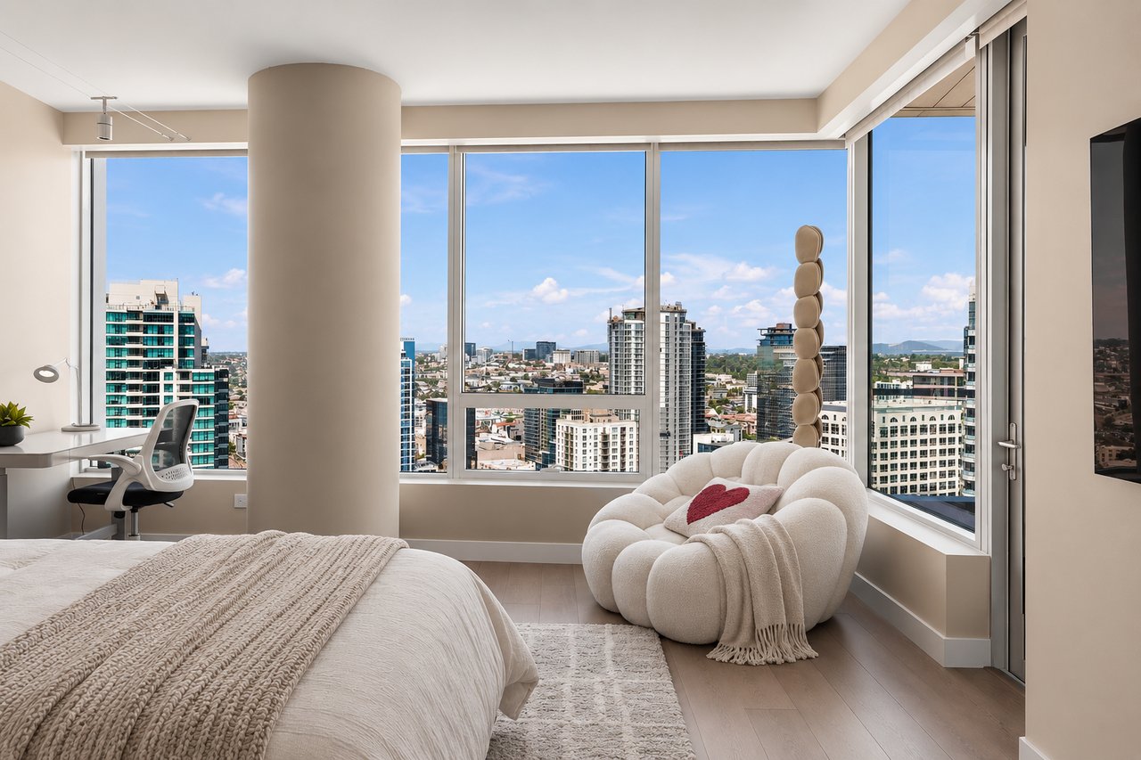 High-rise bedroom with floor-to-ceiling city views and a sculptural white lounge chair.