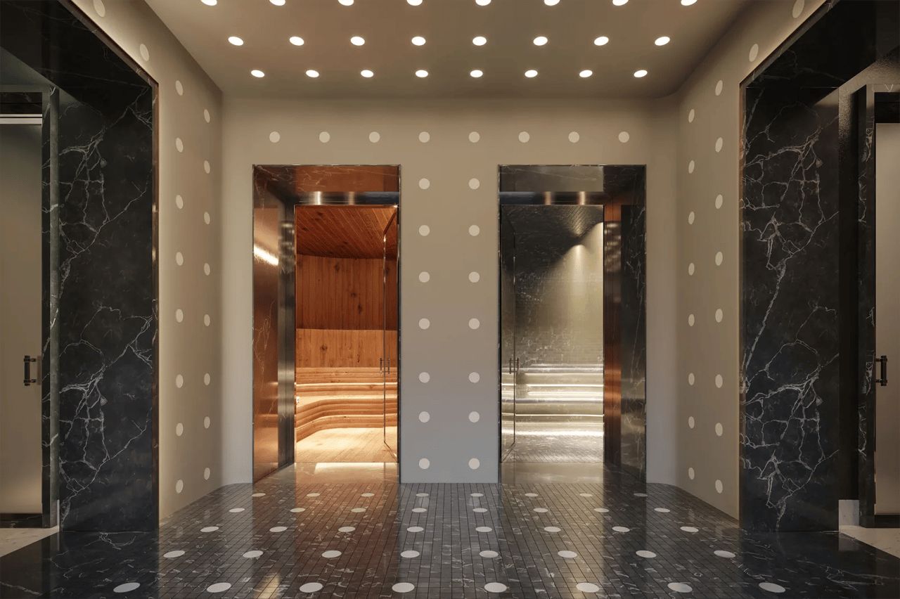 Wellness area with two sauna entrances, dark marble surrounds, and white circular accents.
