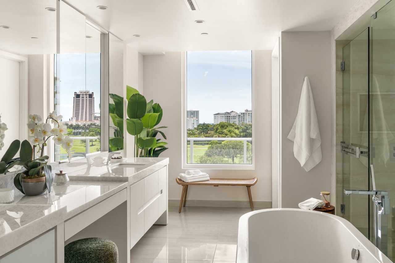 ALINA Residences bathroom in Boca Raton with a freestanding tub, long vanity and glass shower enclosure.