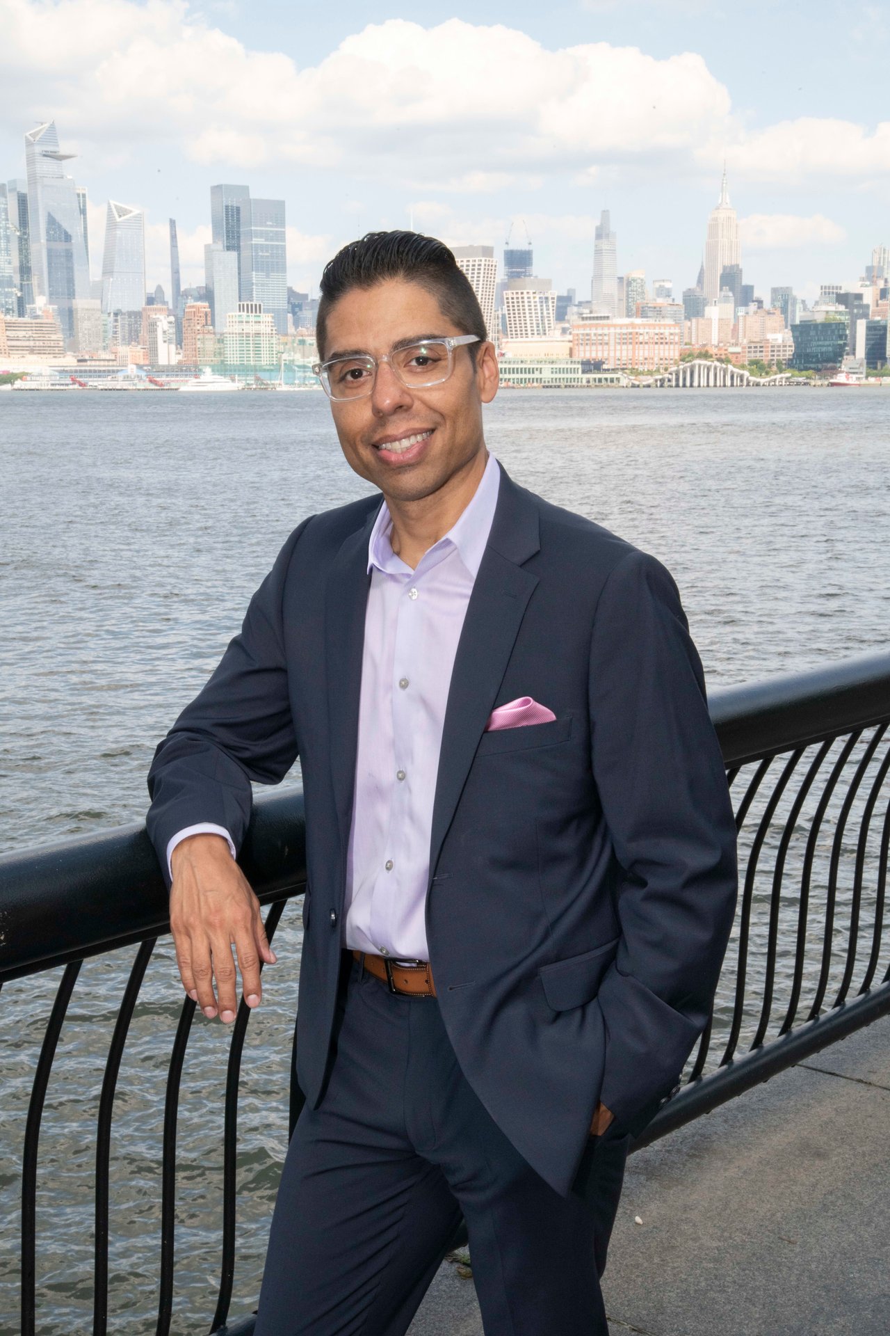 David Guzman, a sophisticated real estate professional, standing by the water's edge.