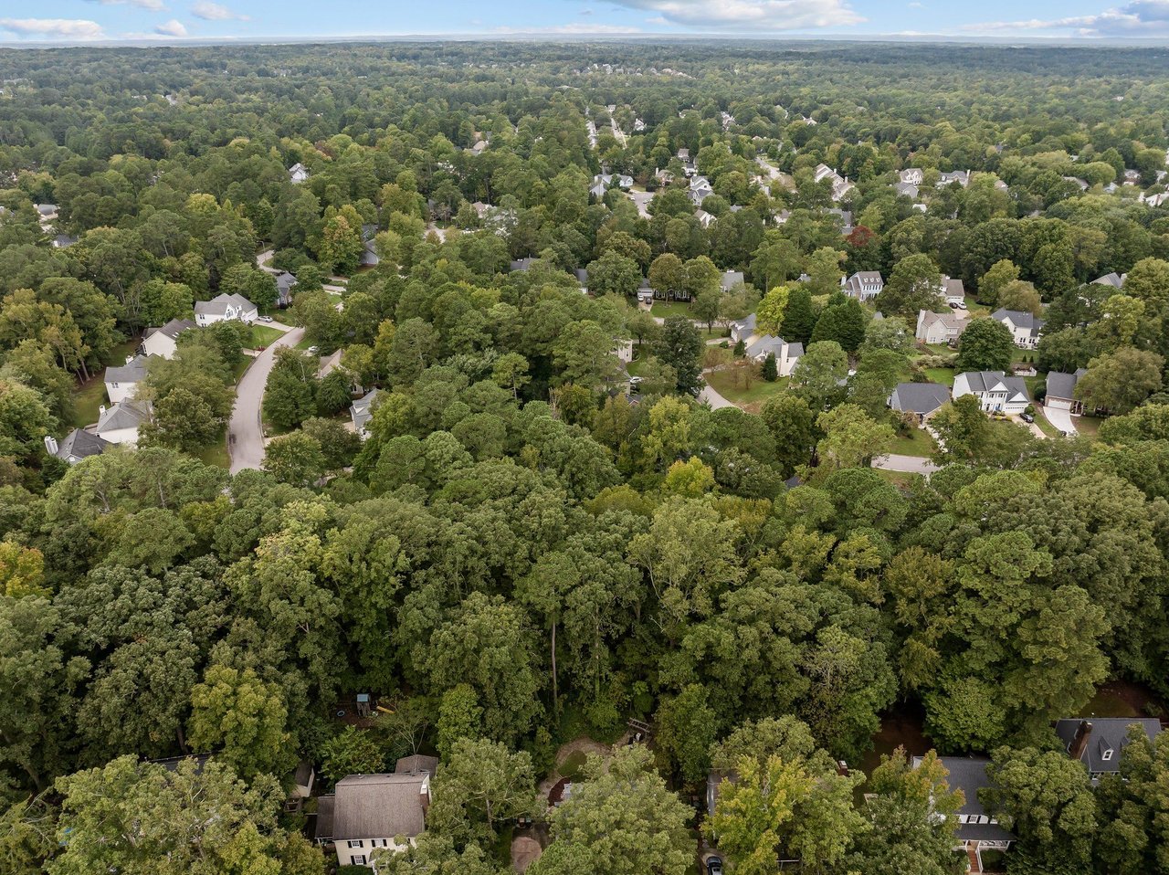 Aerial view of residential neighborhoods in the Raleigh area showing tree-lined communities and housing layouts