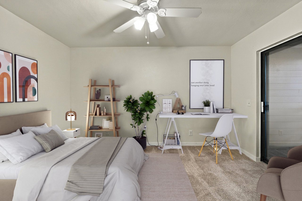 Staged bedroom with a white bed, ladder shelf, potted plants, and desk beside a sliding glass door.