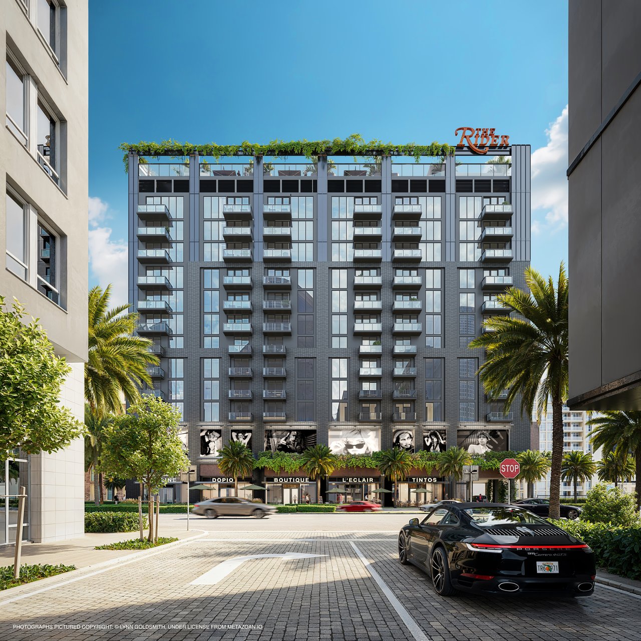 The Rider residential building with glass balconies, rooftop greenery, shops, and palm trees.