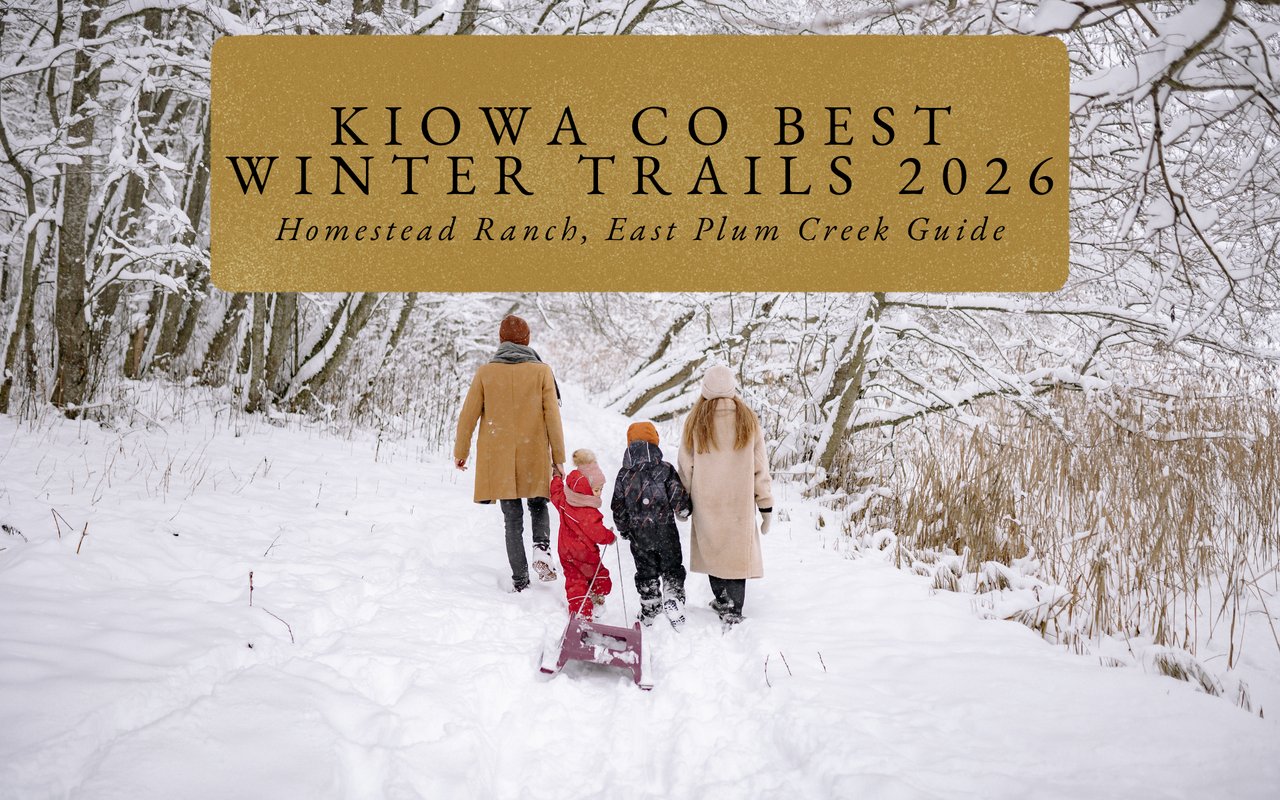  Family hiking up gentle snowy slope toward prehistoric buttes at Pawnee Buttes access trails near Kiowa Colorado.