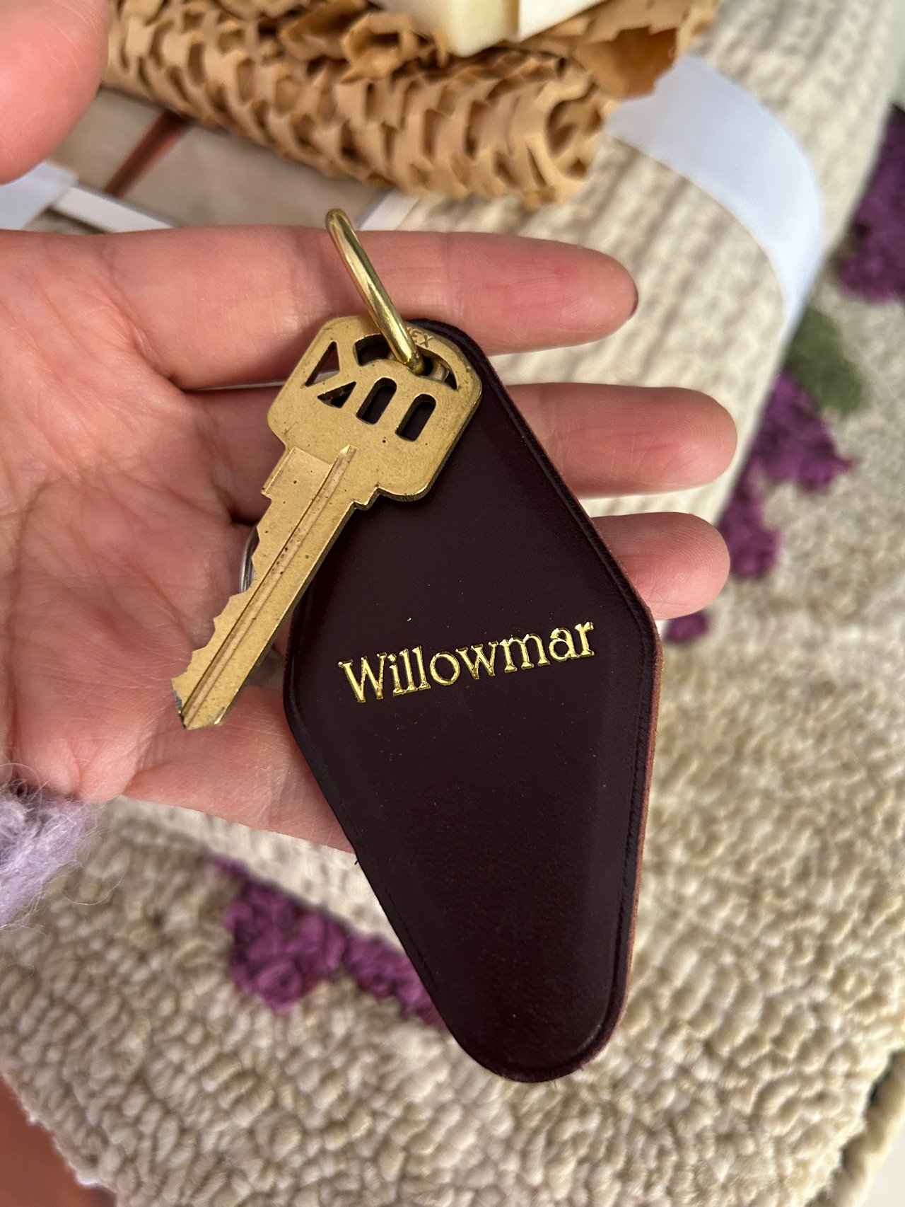 Willowmar-branded leather key fob and brass key held in a hand.