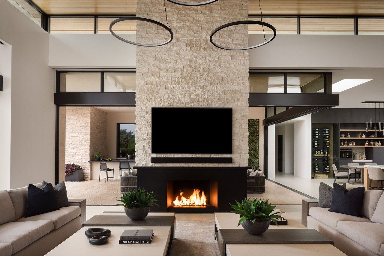 Modern luxury home in Paradise Valley with resort-style backyard, pool, fire feature, and contemporary architecture at sunset.