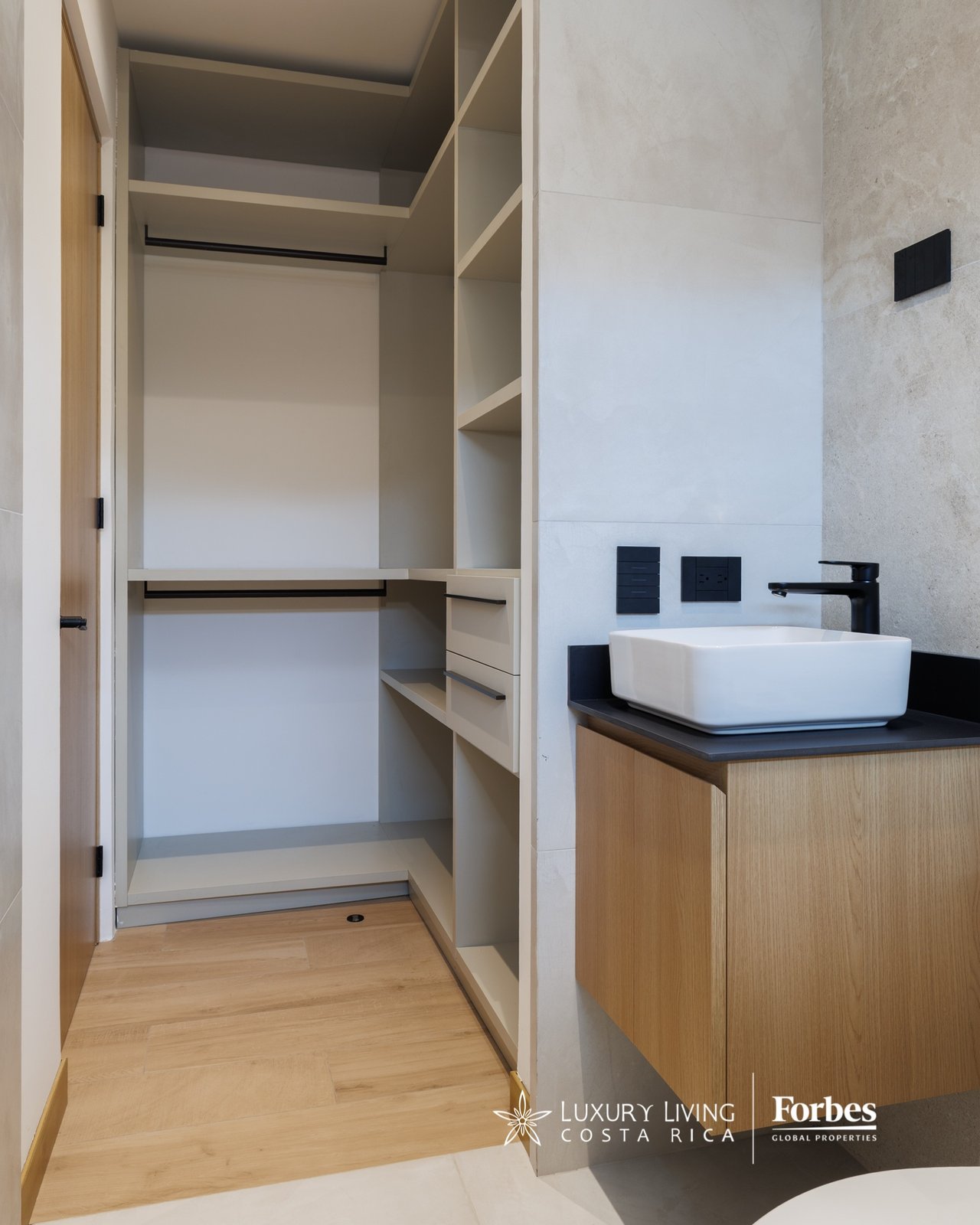 Modern bathroom vanity with a white vessel sink beside an open built-in walk-in closet.