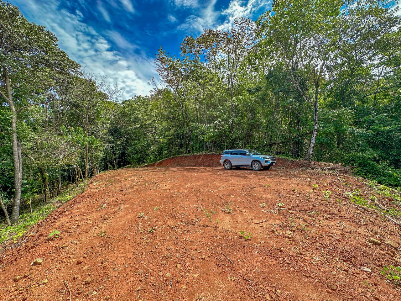 A jungle – and – creek border 1. 6 acre lot in a secure gated community, prepared and ready for your dream home!. 