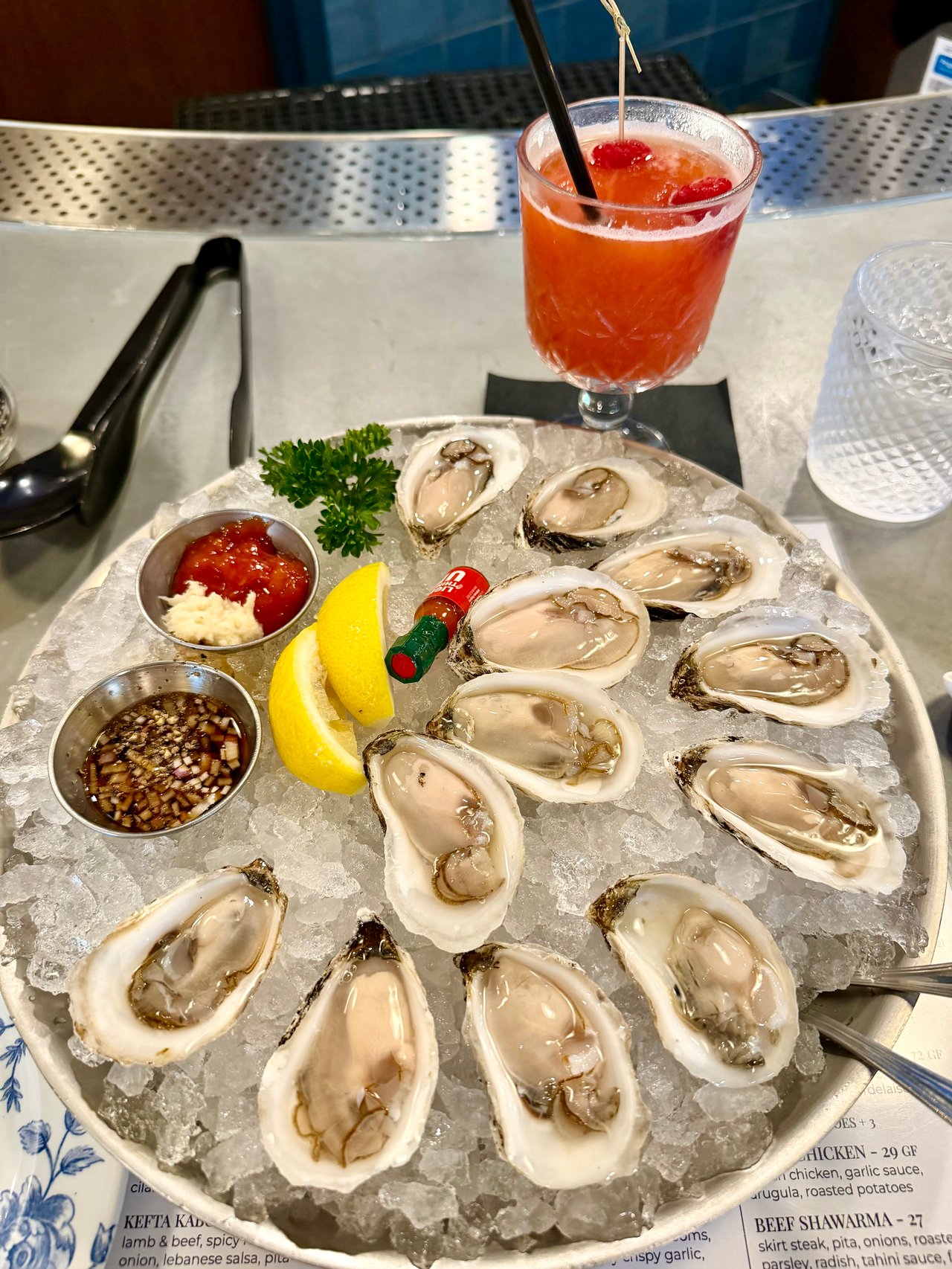 Clean oysters on ice and frozen strawberry cocktail