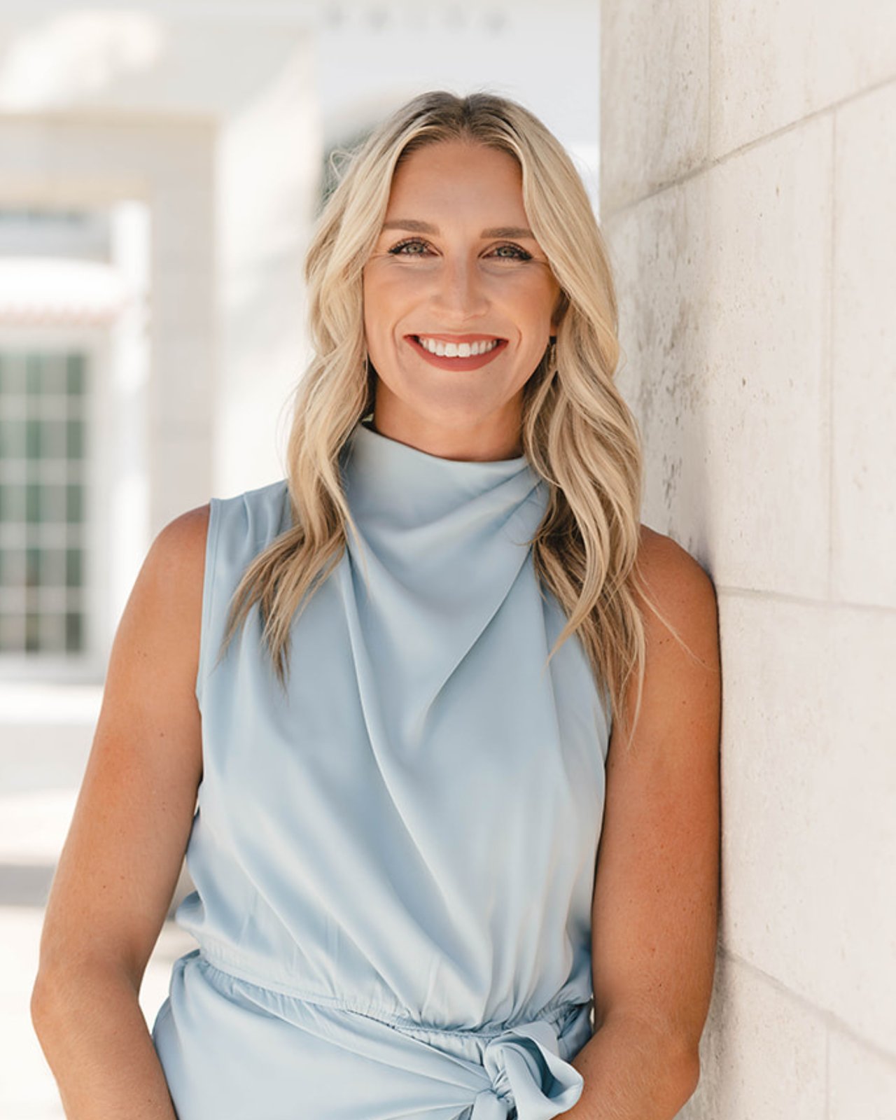 Cassy DeJulio, real estate advisor with The Kendall Hood Collection, smiling in professional headshot