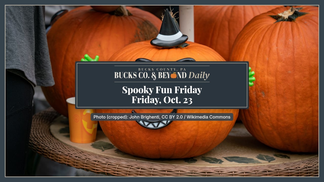 Bright orange pumpkins decorated as silly characters with googly eyes, a pointed witch hat and green felt arms sit on a table at a Halloween party.