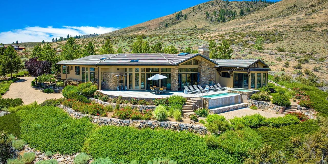 Welcome to one of the most private and expansive lots in all of ArrowCreek, tucked away at the end of a peaceful cul-de-sac in The Reserve. What truly sets this property apart are the stunning panoramic views—golf course, city lights, mountains, and valley all from your own backyard oasis. Enjoy it all from your private pool and hot tub. With floor-to-ceiling windows and skylights throughout, the home is bright and inviting year-round.  Bordering government land on one side and the golf course and a neighbor on the other, this home offers rare privacy, luxury, and space, plus a total of four garage spaces.